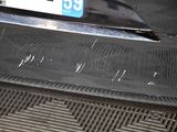 a close up of a car ' s bumper with a number plate on it