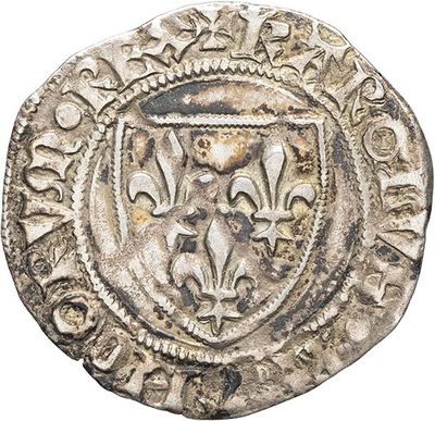 an old silver coin with a lion head on it