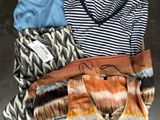 clothes and a purse are laid out on the floor