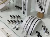 many different types of jewelry on display in a glass case