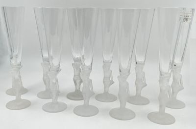 six clear wine glasses with figures on them sitting on a white surface