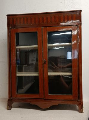 a wooden cabinet with two glass doors on it