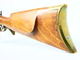 a close up of a rifle on a white surface with a white background