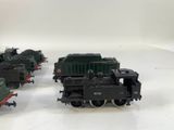three toy trains on a white surface with a white background