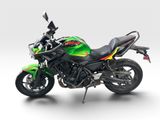 a green and black motorcycle parked on top of a white surface