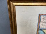 a framed picture of a painting of a man and a woman on a beach
