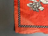 a red cloth with a picture of a man and a horse