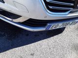 a picture of a white car parked in a parking lot