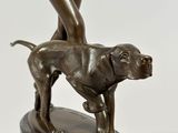 bronze statue of a woman with a dog on a marble base