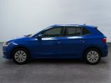the blue car is parked on the concrete floor in the room