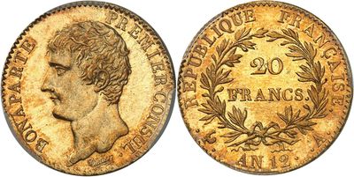 a close up of a gold coin with an image of a man ' s head