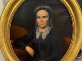 portrait of a woman in a black dress with a gold frame