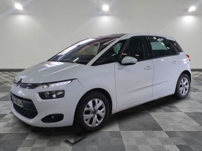 the white citrole is parked on a checkered tile floor