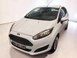 the white car is parked in the white room of the showroom