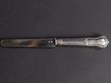 a knife that is laying on a black surface