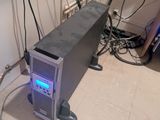 a computer that is sitting on the floor in the corner of the room