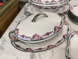 many plates and bowls on a table with a bowl on top of it