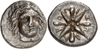 a silver coin with a face of a man on it