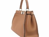a brown leather handbag on a white background
