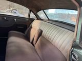 a view of the inside of a car from the driver ' s seat