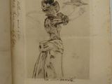 an old book with a drawing of a woman holding a bird on top of it