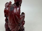statue of a woman sitting on a lotus with a bird in her hand