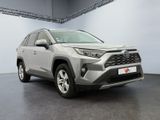 a grey toyota rav is parked in a garage