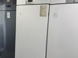 several refrigerators are lined up in a row in a room