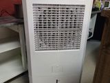 a small air conditioner sitting in the corner of a room