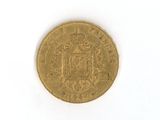 an old gold coin on a white surface with a white background