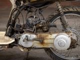 a close up of a motor bike with a rusted tire