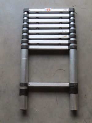 the ladder is leaning up against the wall on the concrete floor
