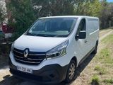 a white van parked on the side of a dirt road
