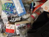 a bag full of items that are sitting on a bed