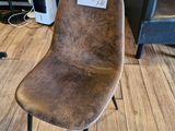 a brown chair with a number on it in a room