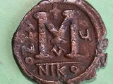 a close up of a coin on a green surface