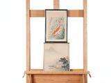 a wooden easel with two paintings on it