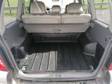 the back of a car with the trunk open and the seats down