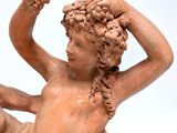 a statue of a woman holding a flower in her hand