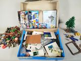 a box full of assorted legos and other toys