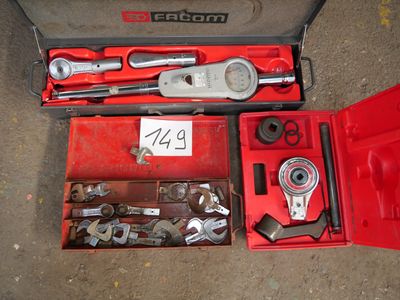 a red tool box with tools in it on the ground