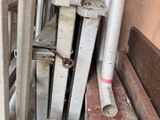 a pile of metal pipes and pipes in a room