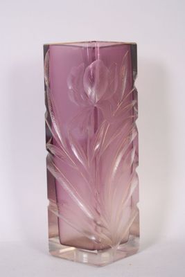un vase en verre contenant une fleur violette