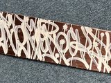 a skateboard with graffiti on it laying on the floor