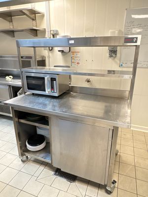 a microwave sitting on top of a stainless steel counter