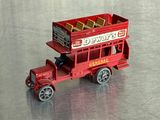 un petit camion rouge en plastique posé sur une table