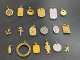 many different types of gold and silver charms on a table