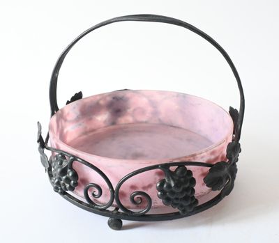 a small pink bowl with black flowers on it