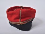 a picture of a red and black hat on a white surface