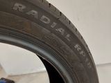 a close up of a tire on a white wall with a sticker